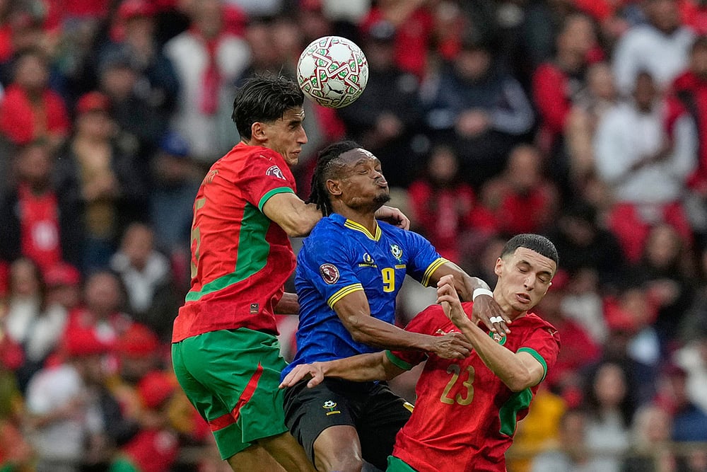 | Photo: AP/Mosa'ab Elshamy : Tanzania's Selamani Mwalimu, center, fights for the ball with Morocco's Nayef Aguerd, left and Bilal El Khannouss during the Africa Cup of Nations round of 16 soccer match between Morocco and Tanzania in Rabat, Morocco.
