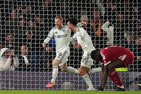 Fulham's Harrison Reed, left, celebrates after scoring his side's second goal during the English Premier League soccer match between Fulham and Liverpool in London.