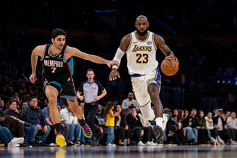 Los Angeles Lakers forward LeBron James (23) drives the ball against Memphis Grizzlies forward Santi Aldama (7) during the second half of an NBA basketball game in Los Angeles.