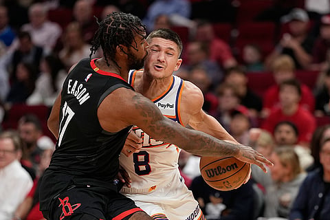 Houston Rockets' Tari Eason (17) defends Phoenix Suns' Grayson Allen (8) during the first half of an NBA basketball game in Houston.