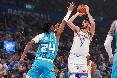 Oklahoma City Thunder center Chet Holmgren (7) looks to shoot over Charlotte Hornets forward Brandon Miller (24) during the first half of an NBA basketball game,  in Oklahoma City. 