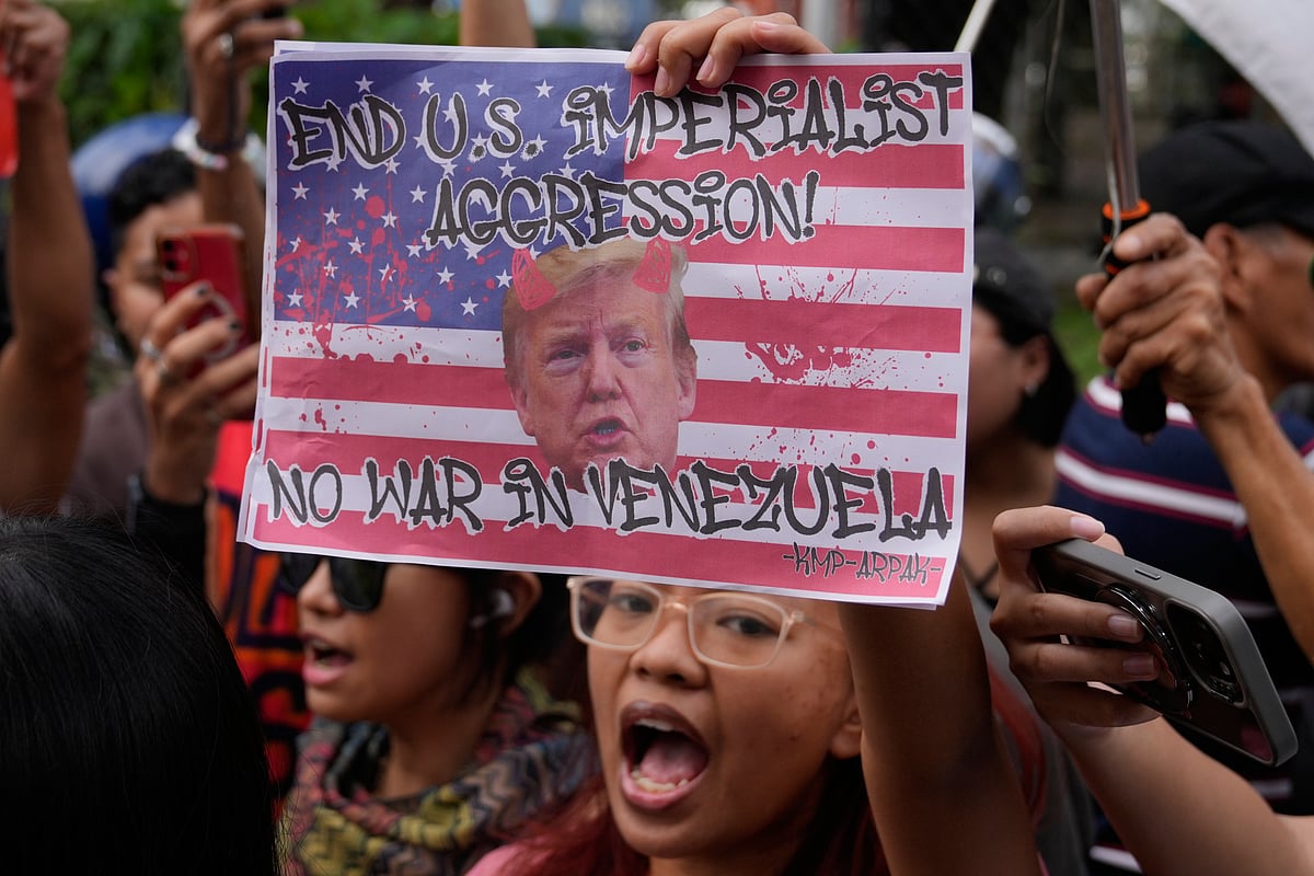 Protesters shout slogans while holding a picture of U.S. President Donald Trump as they denounce the U.S. government and Trump after the U.S. captured Venezuelan President Nicolas Maduro during a rally near the U.S. Embassy in Manila, Philippines on Monday - Aaron Favila