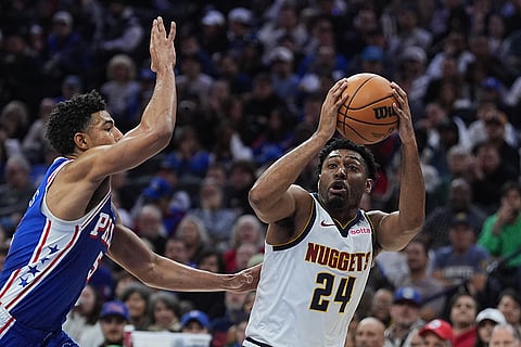Denver Nuggets' Jalen Pickett (24) tries to shoot past Philadelphia 76ers' Quentin Grimes, left, during the second half of an NBA basketball game in Philadelphia.
