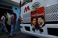 The Global Domino: How US' Action In Venezuela Could Affect China's Taiwan Ambitions AP Photo/Cristian Hernandez : A banner on the front end of a bus features images of Venezuelan President Nicolas Maduro and China's Xi Jinping with a message that reads in Spanish: "An example for the world," during a government-organized rally opposing U.S. intervention, in Caracas, Venezuela.