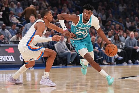 Charlotte Hornets forward Brandon Miller, right, drives past Oklahoma City Thunder guard Aaron Wiggins, left, during the second half of an NBA basketball game, in Oklahoma City.