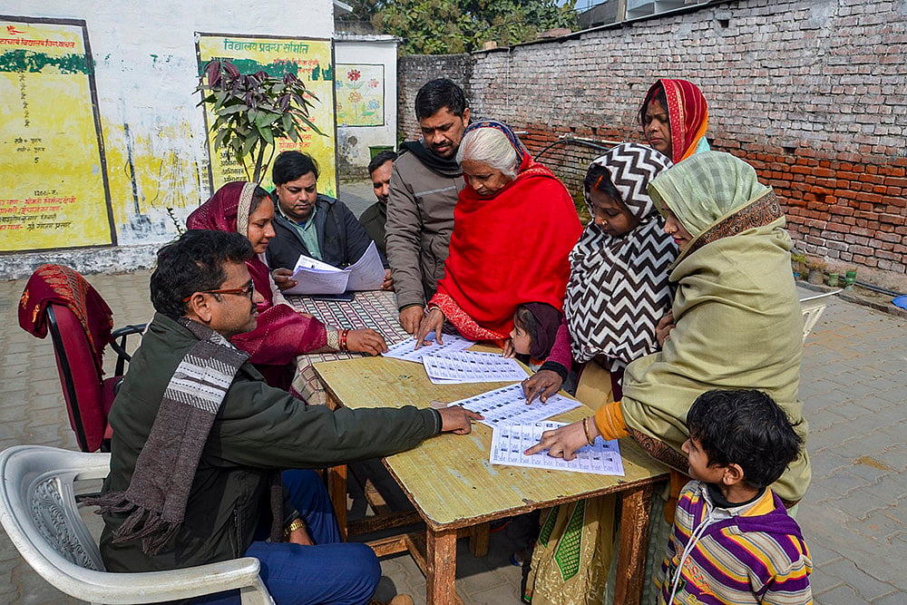People search for their names in the draft voter list after the Special Intensive Revision of electoral rolls in Uttar Pradesh, in Mirzapur, Uttar Pradesh. - | Photo: PTI