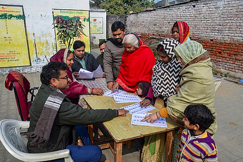 People search for their names in the draft voter list after the Special Intensive Revision of electoral rolls in Uttar Pradesh, in Mirzapur, Uttar Pradesh.