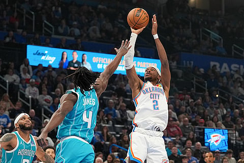 Oklahoma City Thunder guard Shai Gilgeous-Alexander (2) shoots over Charlotte Hornets guard Sion James (4) during the first half of an NBA basketball game, in Oklahoma City.