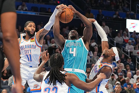 Charlotte Hornets guard Sion James, right, drives past Oklahoma City Thunder guard Shai Gilgeous-Alexander, left, during the second half of an NBA basketball game, in Oklahoma City.