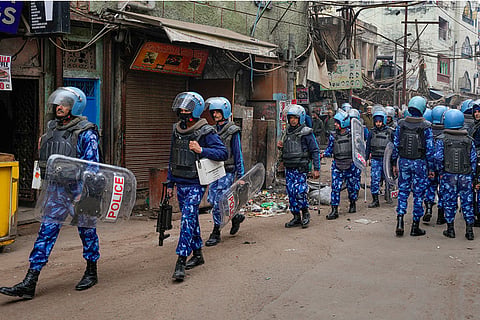 Rapid Action Force (RAF) personnel patrol after violence erupted during a court-mandated demolition on land adjoining the Syed Faiz Elahi Mosque and a nearby graveyard, in New Delhi.