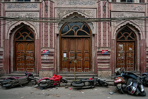 Vehicles lie on ground in the aftermath of violence that erupted during a court-mandated demolition on land adjoining the Syed Faiz Elahi Mosque and a nearby graveyard, in New Delhi.