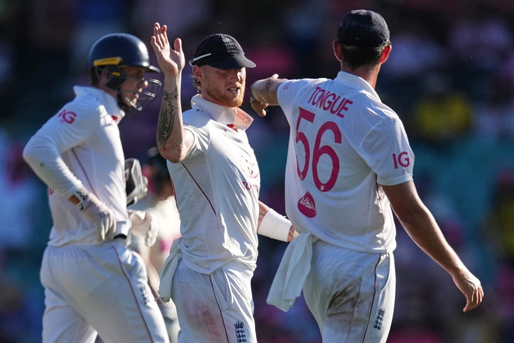 | Photo: AP/Mark Baker : England's Ben Stokes gestures to teammate Josh Tongue, right, as they leave the field on day three of the fifth and final Ashes cricket test between England and Australia in Sydney.