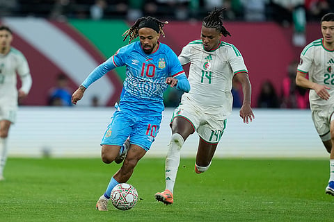 DR Congo's Theo Bongonda, left, controls the ball as Algeria's Hicham Boudaoui tries to stop him during the Africa Cup of Nations round of 16 soccer match between Algeria and DR Congo in Rabat, Morocco.