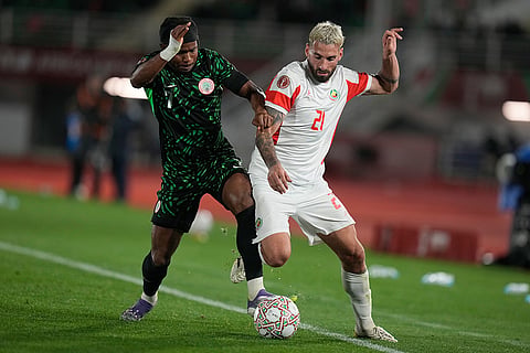 Nigeria's Ademola Lookman, left, and Mozambique's Guima challenge for the ball during the Africa Cup of Nations round of 16 soccer match between Nigeria and Mozambique in Fez, Morocco.