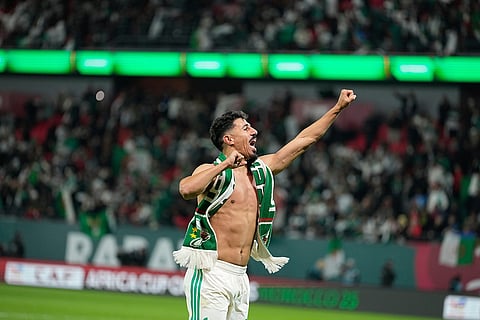 Algeria's Baghdad Bounedjah celebrates after the Africa Cup of Nations round of 16 soccer match between Algeria and DR Congo in Rabat, Morocco.