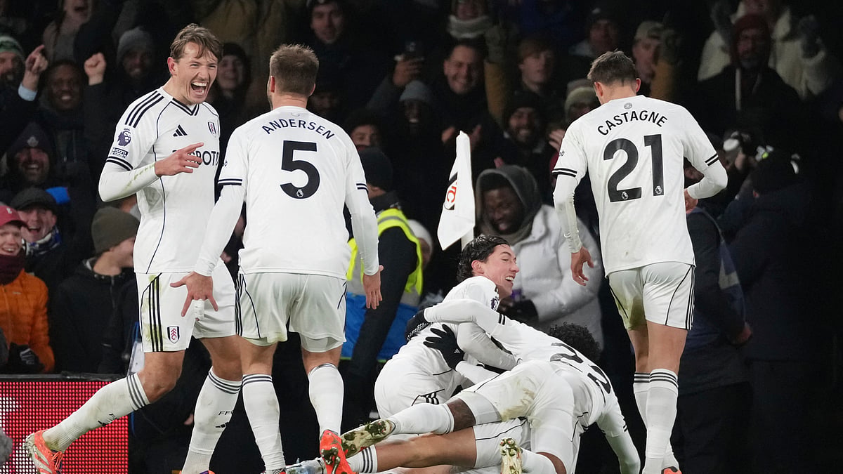 (AP Photo/Dave Shopland) : Fulham's Raul Jimenez, bottom covered, celebrates with teammates after scoring the opening goal during the English Premier League soccer match between Fulham and Chelsea in London, Wednesday, Jan. 7, 2026.