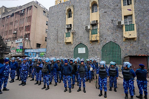 Security personnel stand guard near the Syed Faiz Elahi mosque after the demolition of alleged encroachments from a land adjoining the mosque and a nearby graveyard carried out by the Municipal Corporation of Delhi (MCD), at Turkman Gate area, in New Delhi.