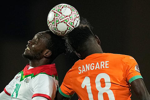 Ivory Coast's Ibrahim Sangare, right, challenges Burkina Faso's Saidou Simpore during the Africa Cup of Nations best of 16 soccer match between Ivory Coast and Burkina Faso in Marrakech, Morocco.