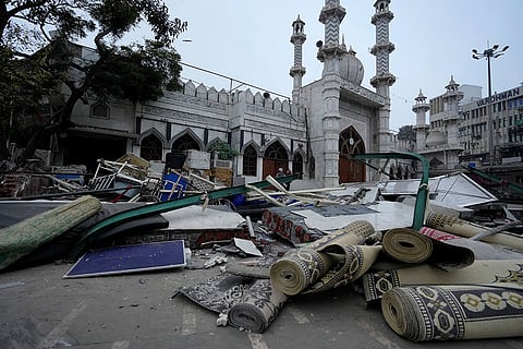 Debris and belongings lie outside the Syed Faiz Elahi mosque after the demolition of alleged encroachments from a land adjoining the mosque carried out by the Municipal Corporation of Delhi (MCD), at Turkman Gate area, in New Delhi.