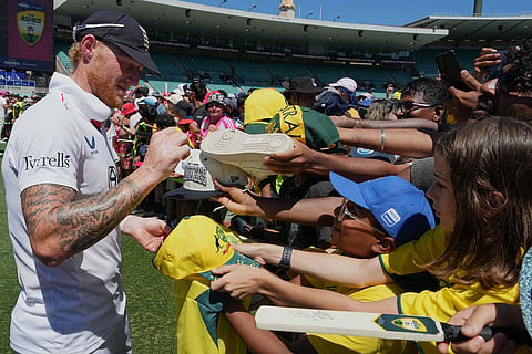England's Ben Stokes signs his autograph for a fan following the fifth and final Ashes cricket test between England and Australia in Sydney.