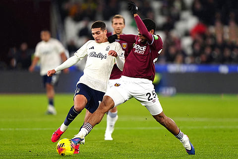 West Ham United's Jean-Clair Todibo, right, and Nottingham Forest's Nicolas Dominguez  in action during the English Premier League soccer match between West Ham United and Nottingham Forest in London.