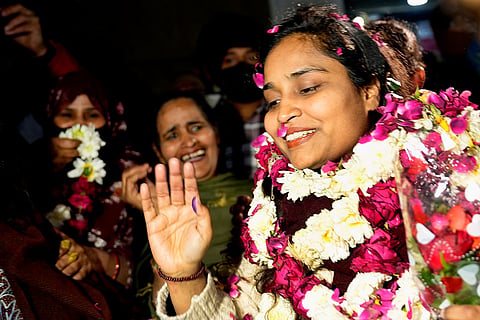 Friends and family welcome Gulfisha with garlands and flowers.