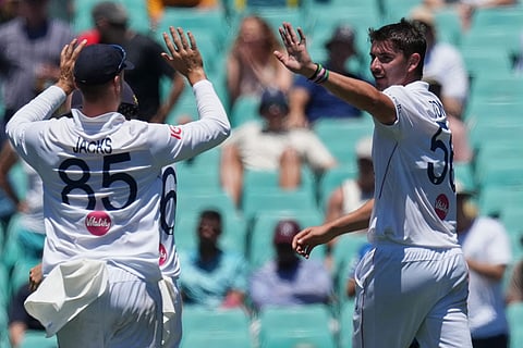 England's Josh Tongue, right ,is congratulated by teammate Will Jacks after taking the wicket of Australia's Jake Weatherald during play on the last day of the fifth and final Ashes cricket test between England and Australia in Sydney.