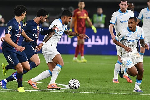 Marseille's Emerson Palmieri, center, is challenged during the French Super Cup soccer match between PSG and Marseille in Kuwait City, Kuwait.