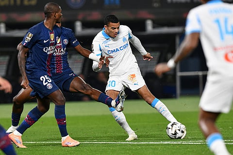Marseille's Mason Greenwood, center, takes a shot during the French Super Cup soccer match between PSG and Marseille in Kuwait City, Kuwait.
