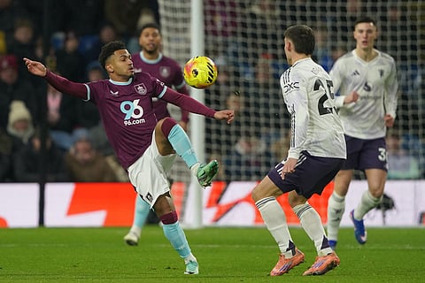 Burnley's Marcus Edwards receives the ball in front of Manchester United's Manuel Ugarte during the Premier League soccer match between Burnley and Manchester United in Burnley, England.