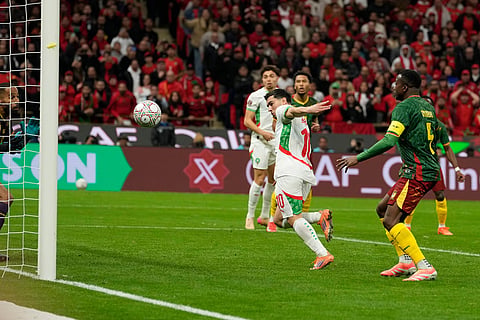Morocco's Brahim Abdelkader Díaz, right, scores his side's opening goal during the Africa Cup of Nations quarterfinal soccer match between Cameroon and Morocco, in Rabat, Morocco.
