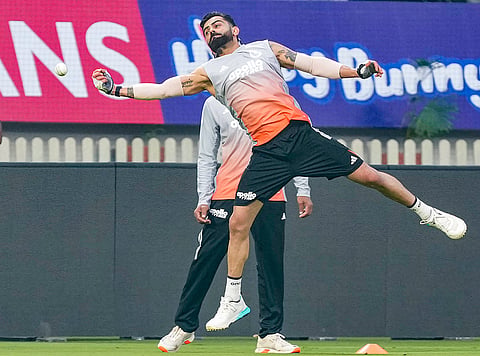 India’s Virat Kohli tries to catch the ball during a practice session ahead of the first ODI cricket match of a series between India and New Zealand, at Kotambi Stadium, in Vadodara, Gujarat.