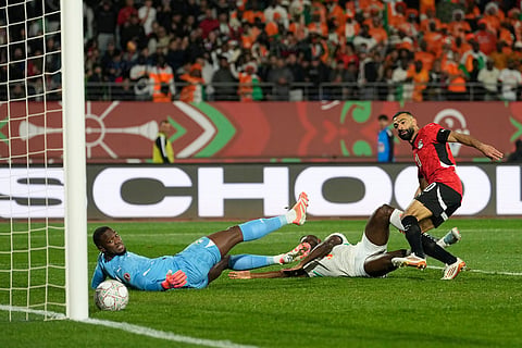Egypt's Mohamed Salah, right, scores his side's third goal during the Africa Cup of Nations quarterfinal soccer match between Egypt and Ivory Coast, in Agadir, Morocco.