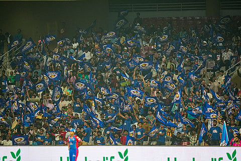 Fans cheer in the stands during a Women's Premier League (WPL) T20 cricket match between Mumbai Indians and Delhi Capitals, at the DY Patil Stadium, in Navi Mumbai.