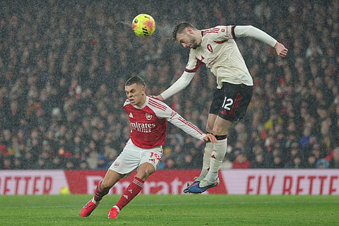 Liverpool's Conor Bradley heads the ball over Arsenal's Leandro Trossard during the English Premier League soccer match between Arsenal and Liverpool in London.
