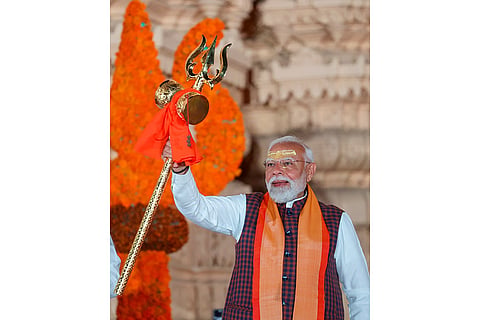 In this image released on Jan. 10, 2026, Prime Minister Narendra Modi holds a 'trishul', a trident, during the 'Somnath Swabhiman Parv' celebration at the Somnath Temple, in Gir Somnath district, Gujarat.