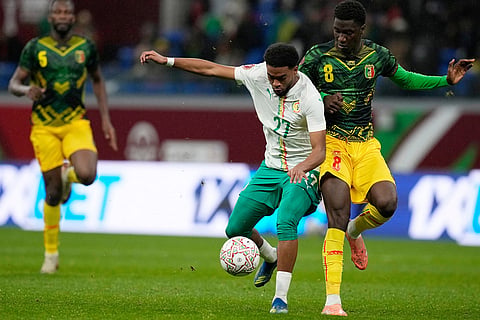 Senegal's Ibrahim Mbaye, left, and Mali's Mahamadou Doumbia fight for the ball during the Africa Cup of Nations quarterfinal soccer match between Senegal and Mali in Tangier, Morocco.