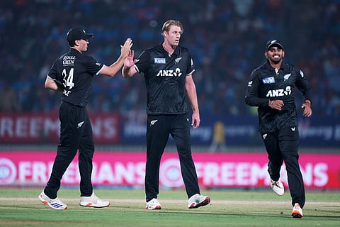 New Zealand's Kyle Jamieson, center, celebrates with teammate Kristian Clarke the wicket of India's Rohit Sharma during the first One Day International cricket match between India and New Zealand in Vadodara, India.