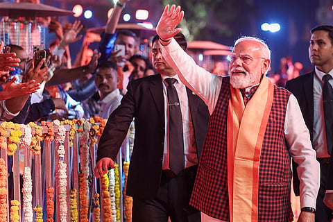 In this image released on Jan. 10, 2026, Prime Minister Narendra Modi greets people as he arrives  during the 'Somnath Swabhiman Parv' celebration, in Gir Somnath district, Gujarat.