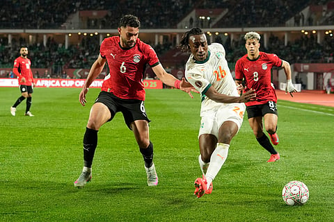 Ivory Coast's Yan Diomande, center right, is challenged by Egypt's Yasser Ibrahim during the Africa Cup of Nations quarterfinal soccer match between Egypt and Ivory Coast, in Agadir, Morocco.