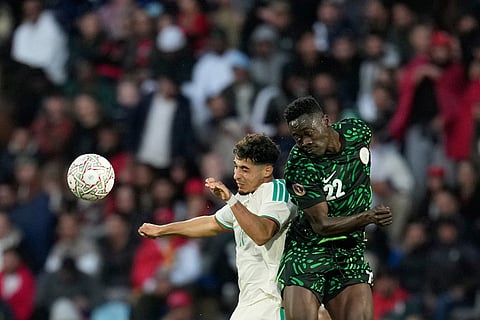 Algeria's Fares Chaibi, left, and Nigeria's Akor Adams challenge for the ball during the Africa Cup of Nations quarterfinal soccer match between Nigeria and Algeria, in Marrakech, Morocco.