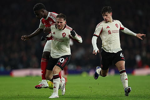 Arsenal's Bukayo Saka, left, and Liverpool's Alexis Mac Allister fight for the ball during the English Premier League soccer match between Arsenal and Liverpool in London.