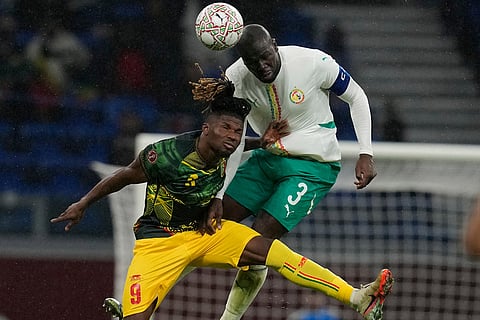 Mali's El Bilal Toure, left, and Senegal's Kalidou Koulibaly jump for the ball during the Africa Cup of Nations quarterfinal soccer match between Senegal and Mali in Tangier, Morocco.