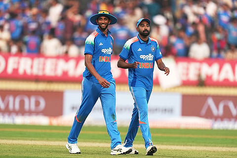India's Prasidh Krishna, left, and teammate Mohammed Siraj leave the field at the end of New Zealand's innings during the first One Day International cricket match between India and New Zealand in Vadodara, India.