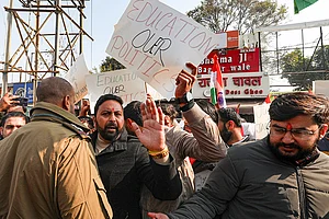 Photo: PTI : Student wing of the National Conference hold placards during a protest against the withdrawal of the permission letter for Shri Mata Vaishno Devi Medical College, in Jammu.