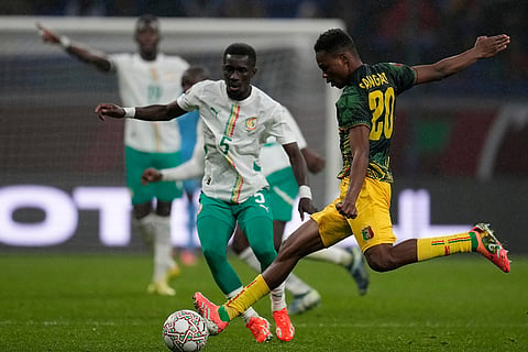 Mali's Mamadou Sangarem, passes the ball as Senegal's Idrissa Gueye defends during the Africa Cup of Nations quarterfinal soccer match between Senegal and Mali in Tangier, Morocco.