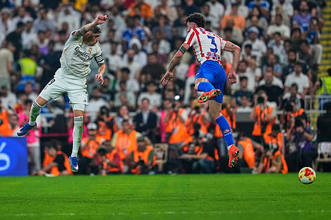 Real Madrid's Federico Valverde, left, and Atletico Madrid's Matteo Ruggeri jump for the ball during the Spanish Super Cup semifinal soccer match at King Abdullah Sports City Stadium in Jeddah, Saudi Arabia.