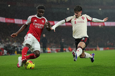 Liverpool's Milos Kerkez blocks Arsenal's Bukayo Saka during the English Premier League soccer match between Arsenal and Liverpool in London.