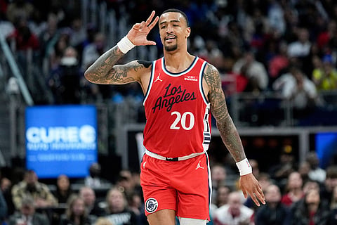 Los Angeles Clippers forward John Collins celebrates after a 3-point basket during the second half of an NBA basketball game against the Detroit Pistons in Detroit.