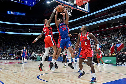 Detroit Pistons forward Tolu Smith, center, shoots against Los Angeles Clippers forward John Collins, forward Nic Batum, and guard Kris Dunn, from left, during the first half of an NBA basketball game in Detroit.